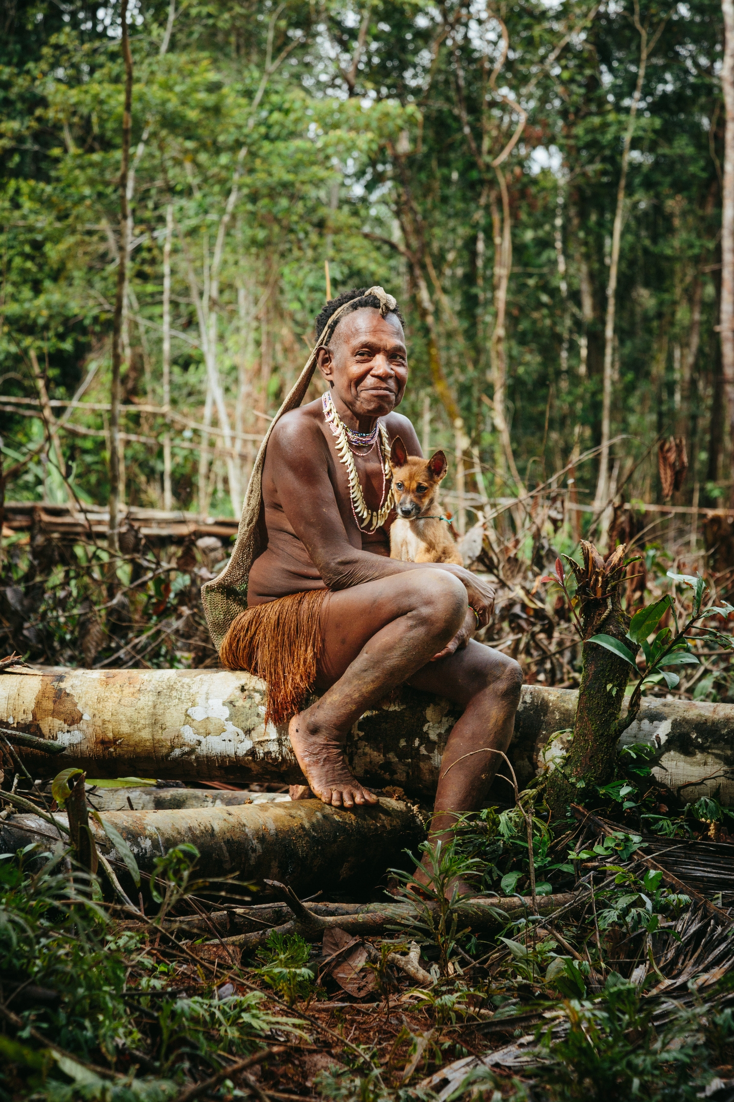 An elder laughing at me as I try to climb a tree.